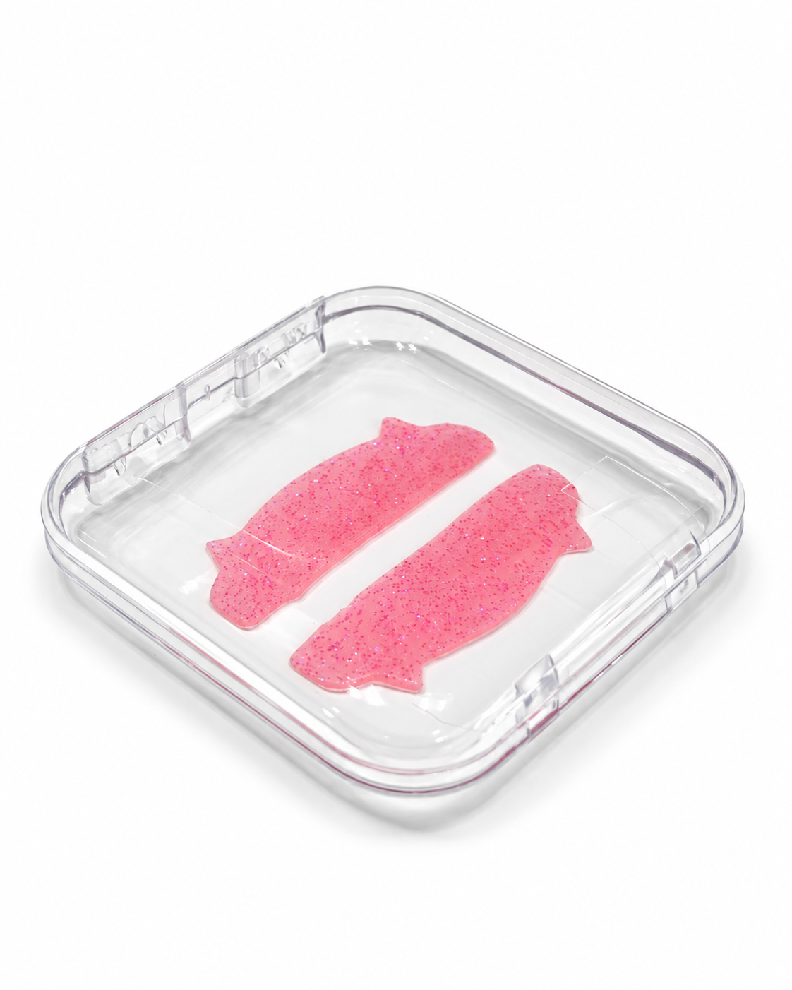 Caja acrílica transparente de 75 × 75 mm cerrada, con dos parches rosas de silicona visibles en su interior.